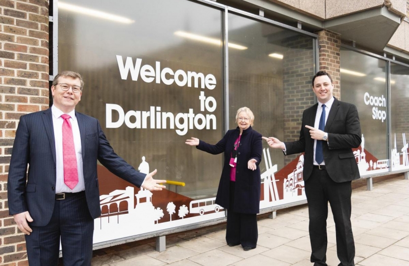 Peter Gibson MP, Cllr Heather Scott OBE and Mayor Ben Houchen in front of the "Welcome to Darlington" sign